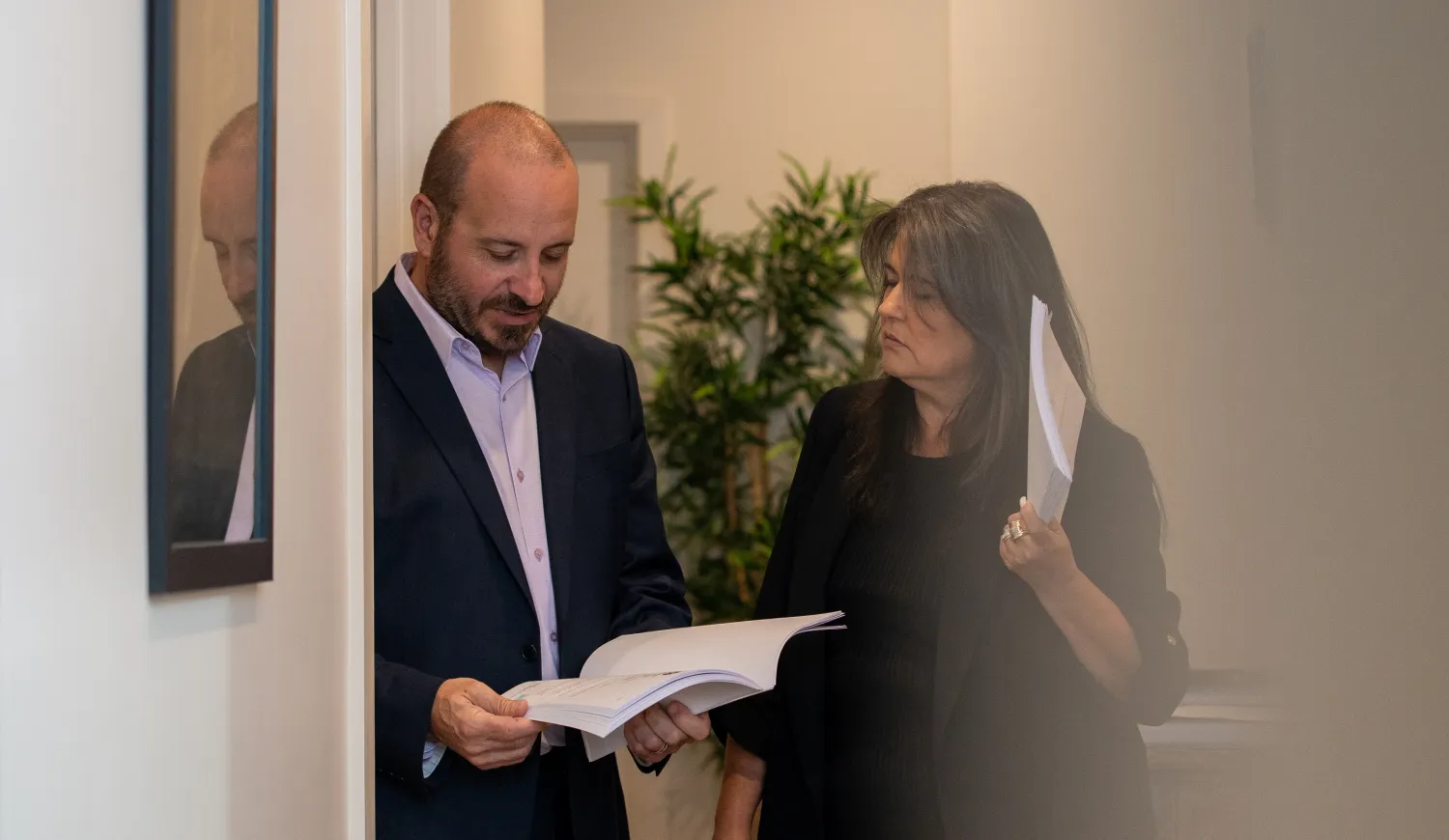 Phil Testa and Lauraine Evans discussing a case in the hallway.