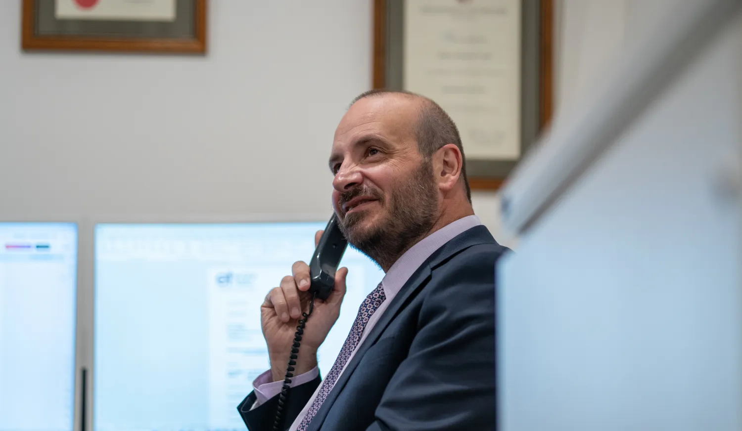 Phil Testa talking with a client on the phone.
